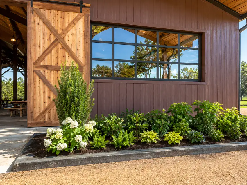 Barn entry with hydrangeas, ferns and a foundation planting bed — Ranch Services