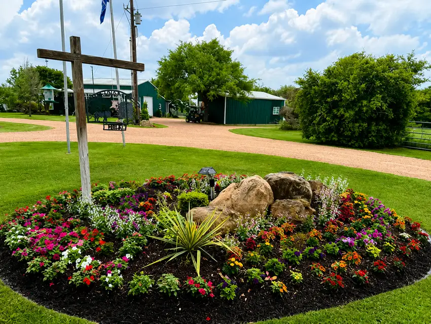 Circular color bed with boulders at a ranch entrance — Seasonal Color Enhancements
